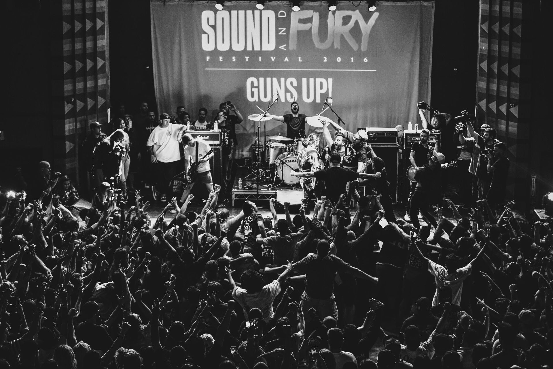 Guns Up! on stage at Sound and Fury 2016, crowd with fists up